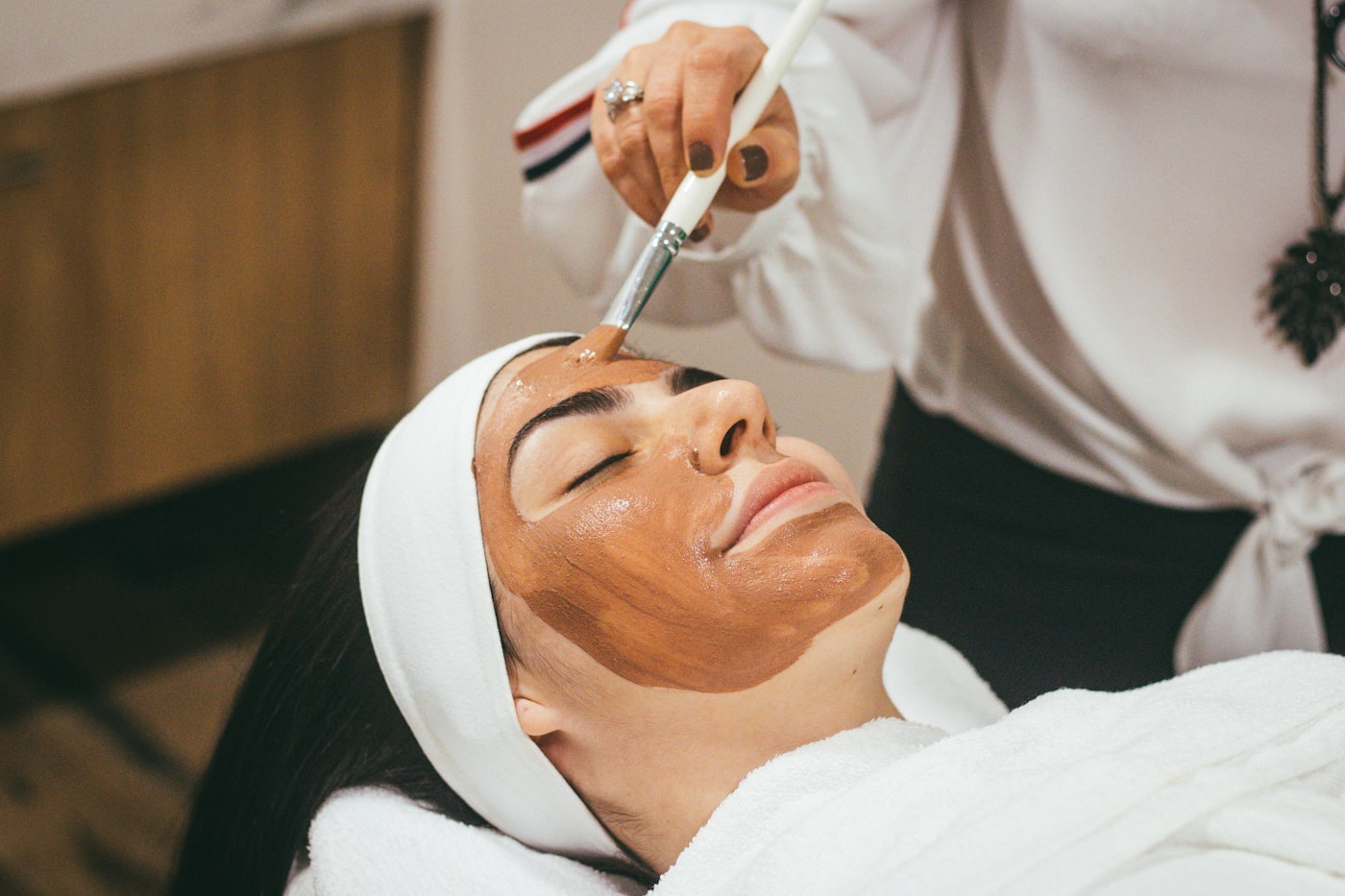 Aesthetician performing a facial treatment at a med spa